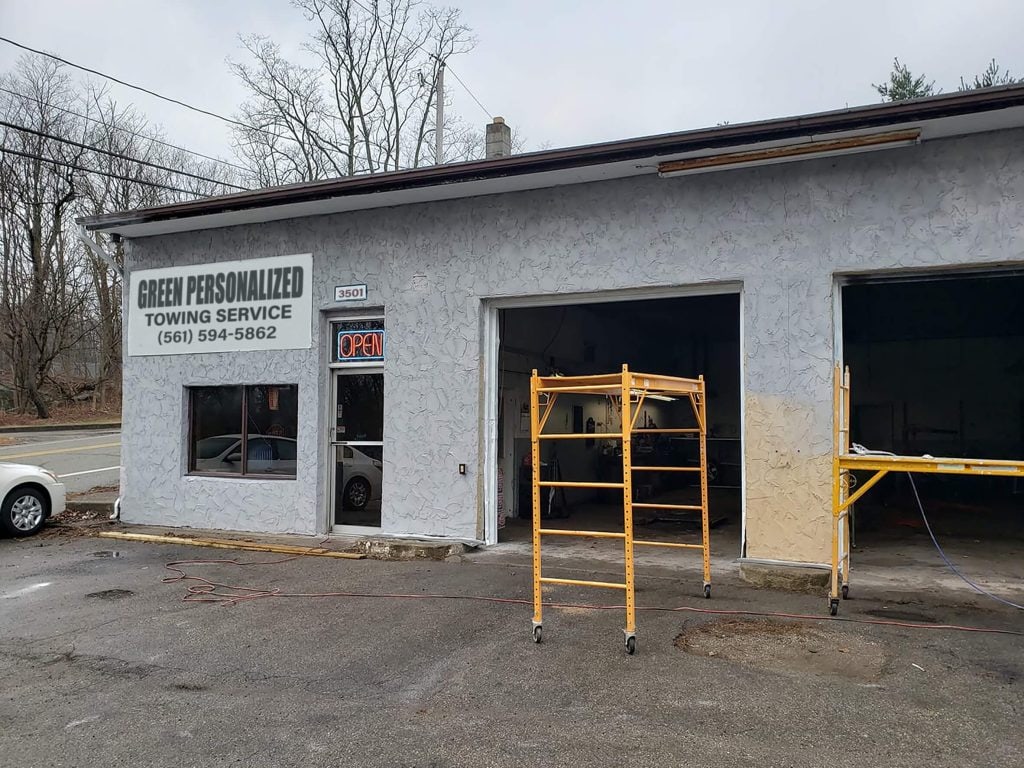 Green Personalized Towing Service storefront sign
